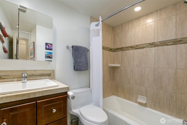 bathroom featuring toilet, vanity, and  shower combination