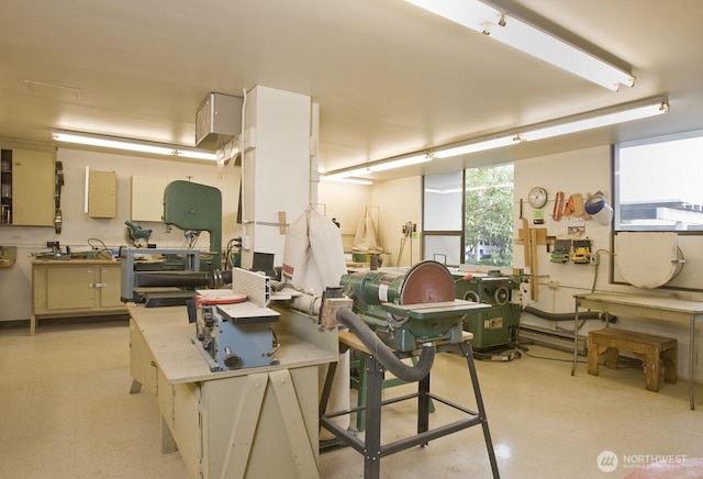 interior space with a workshop area and light floors