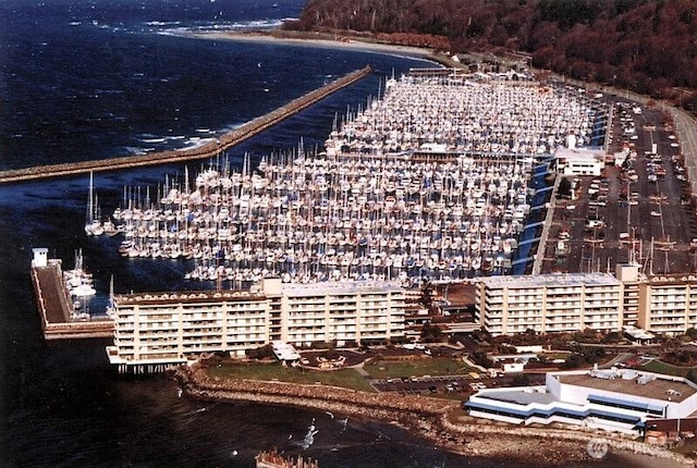 birds eye view of property with a view of city and a water view