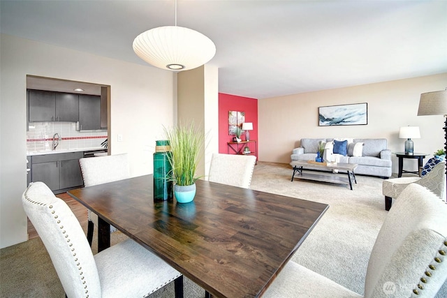 dining area featuring light colored carpet