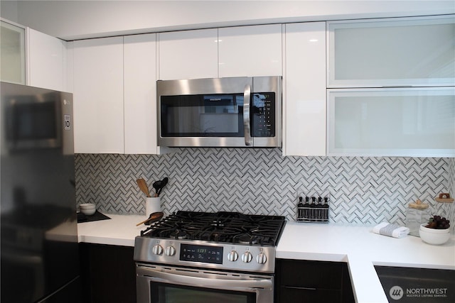 kitchen featuring modern cabinets, appliances with stainless steel finishes, light countertops, and white cabinetry