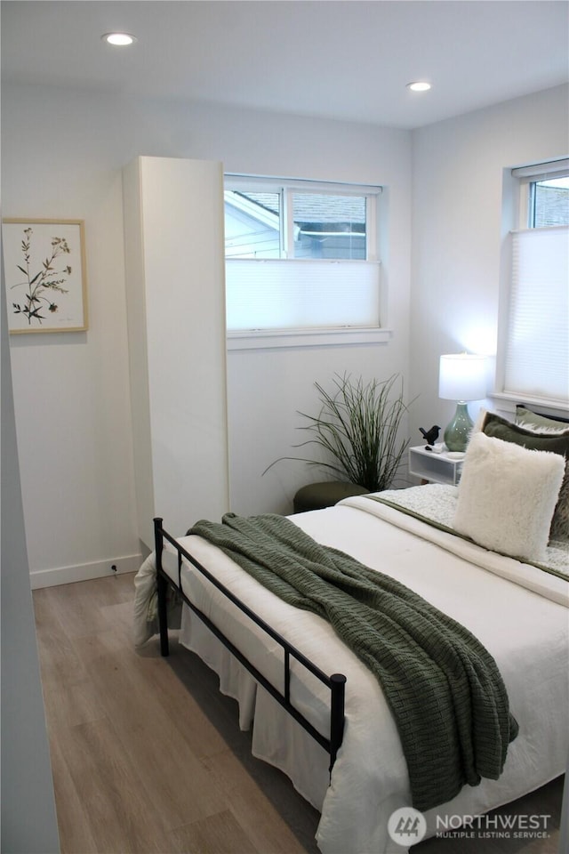 bedroom featuring recessed lighting, wood finished floors, and baseboards