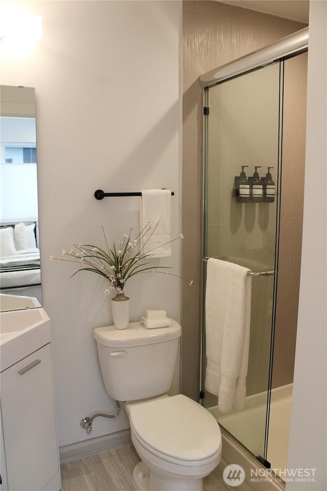 bathroom with vanity, toilet, and a stall shower