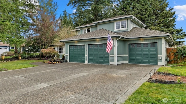 view of front facade featuring a garage, roof with shingles, and driveway