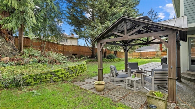 view of yard with a gazebo, a fenced backyard, and a patio area