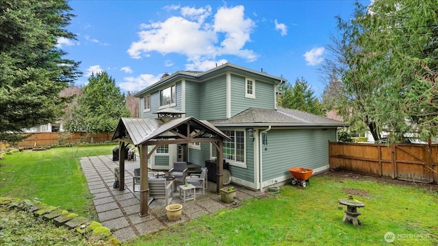 back of house featuring a gazebo, a yard, a fenced backyard, and a patio area