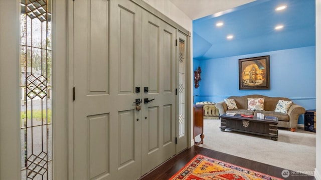 foyer featuring recessed lighting, lofted ceiling, and dark wood-style flooring