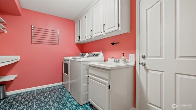 laundry area featuring baseboards, cabinet space, and independent washer and dryer