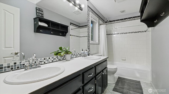 bathroom with a sink, shower / bath combo with shower curtain, toilet, and double vanity