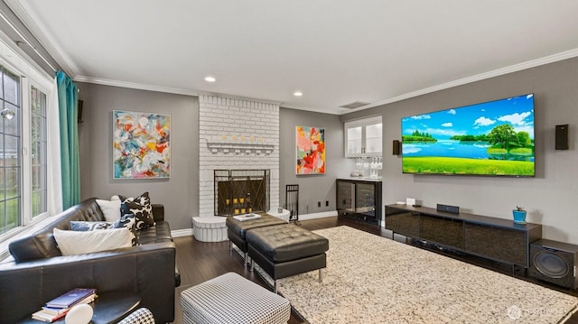 living area featuring visible vents, dark wood-style floors, ornamental molding, and a fireplace