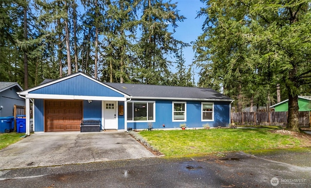 ranch-style house featuring an attached garage, concrete driveway, a front lawn, and fence