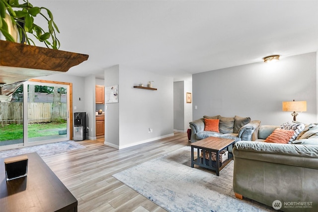 living area with light wood-style flooring and baseboards