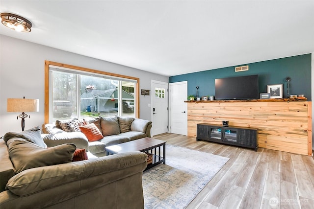 living room with visible vents and wood finished floors