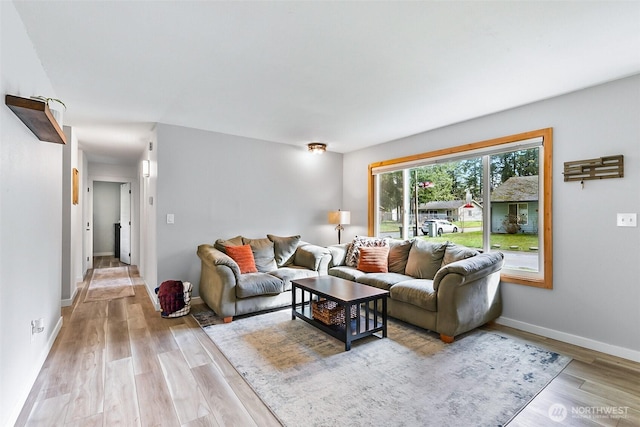 living area with light wood finished floors and baseboards