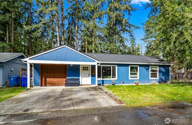 single story home with a front yard, an attached garage, fence, and driveway