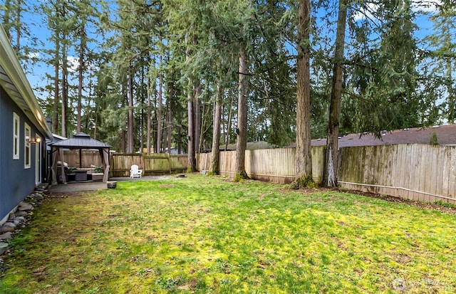 view of yard with a gazebo, a fenced backyard, and a patio area