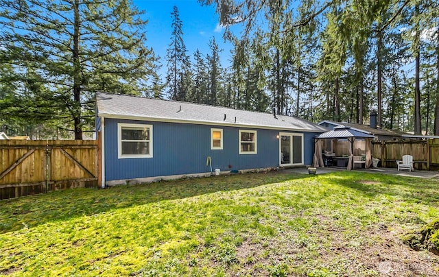 rear view of property with fence, a gazebo, a lawn, a patio, and a gate