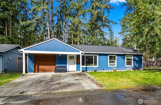 ranch-style home featuring driveway, an attached garage, a front yard, and fence