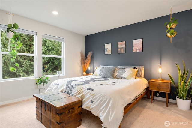 bedroom with light carpet and baseboards