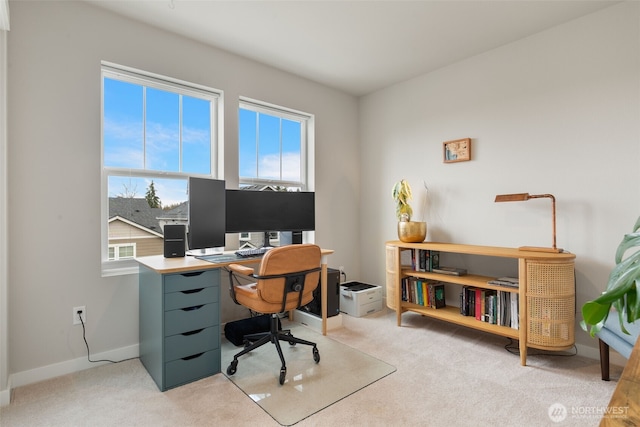 home office featuring light carpet and baseboards