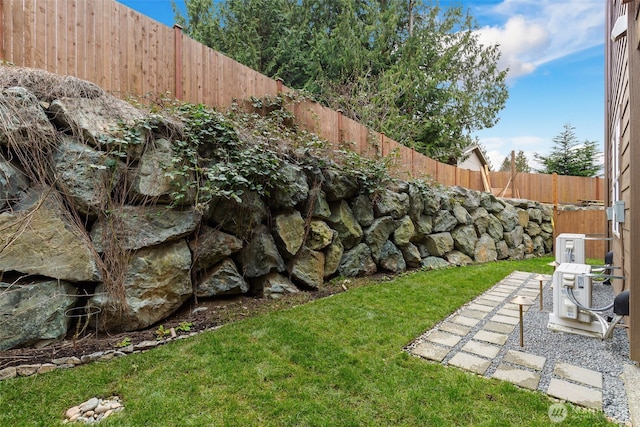 view of yard featuring central AC unit, a fenced backyard, and a patio area