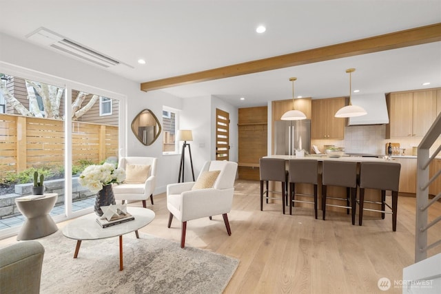 living room with beam ceiling, light wood-style flooring, and recessed lighting