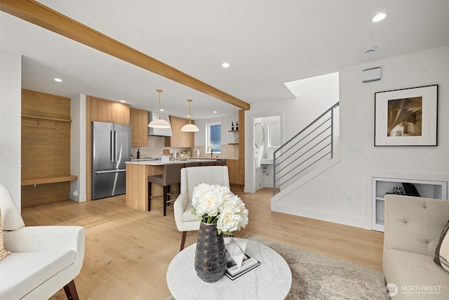 living room with stairs, recessed lighting, and light wood-type flooring