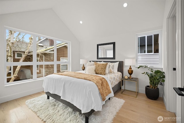 bedroom with high vaulted ceiling, recessed lighting, baseboards, and light wood-style floors