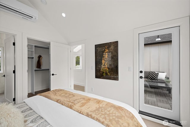 bedroom with a walk in closet, recessed lighting, a wall mounted AC, and lofted ceiling