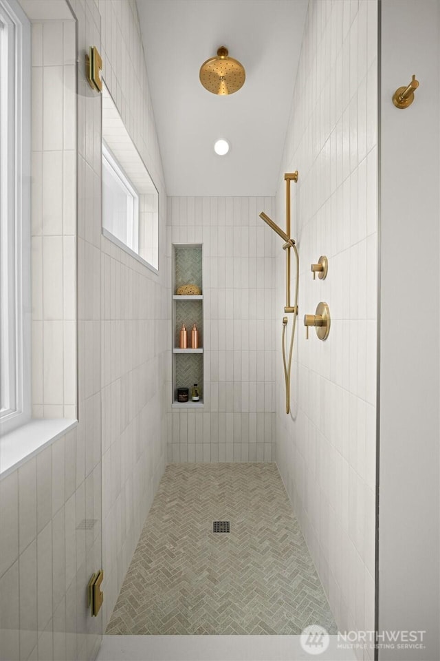 full bathroom with recessed lighting and tiled shower