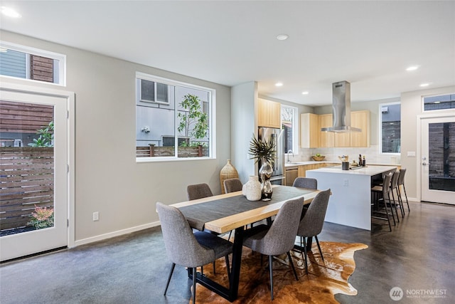 dining room with recessed lighting, concrete floors, and baseboards