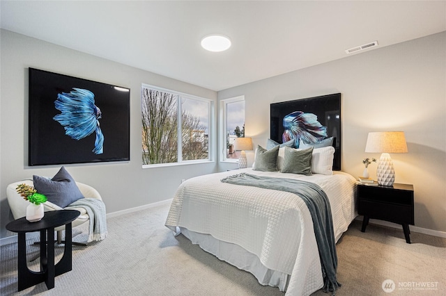 carpeted bedroom featuring visible vents and baseboards