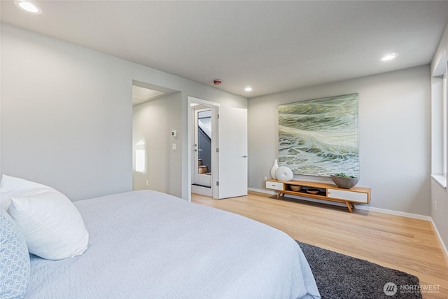 bedroom with recessed lighting, baseboards, and wood finished floors