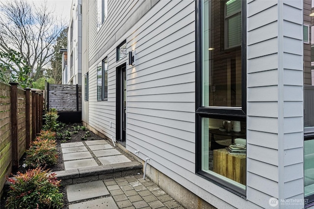 view of side of home featuring fence