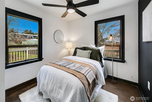 bedroom with wood finished floors, baseboards, and ceiling fan