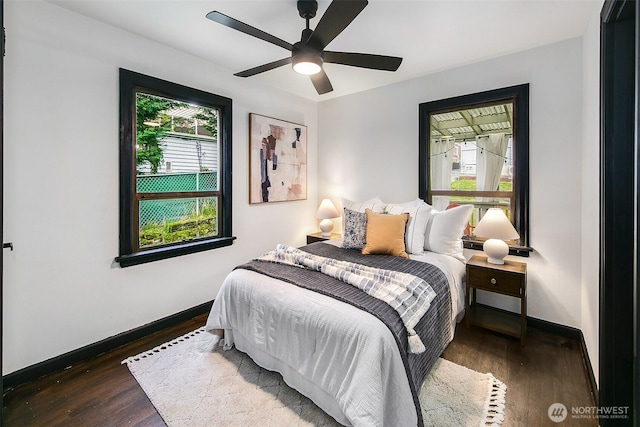 bedroom with a ceiling fan, baseboards, and wood finished floors