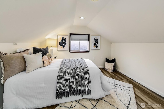 bedroom featuring vaulted ceiling, wood finished floors, and baseboards