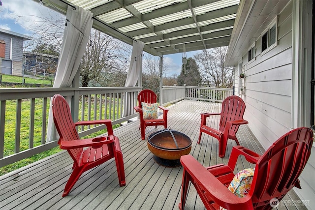 wooden terrace with a fire pit