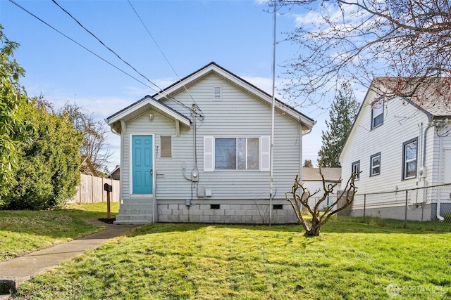 bungalow-style house featuring crawl space, entry steps, a front lawn, and fence