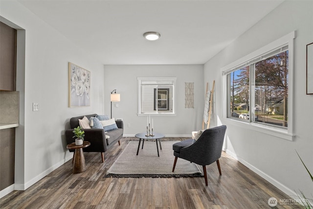 living area featuring wood finished floors and baseboards