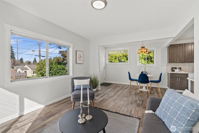 living area with wood finished floors and baseboards