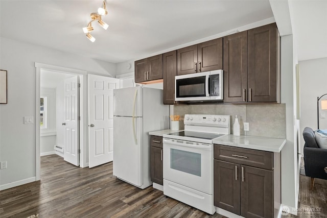 kitchen featuring white appliances, dark brown cabinetry, light countertops, decorative backsplash, and dark wood-style flooring