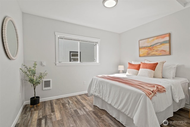 bedroom featuring wood finished floors and baseboards