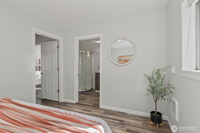 bedroom featuring connected bathroom, baseboards, visible vents, and wood finished floors