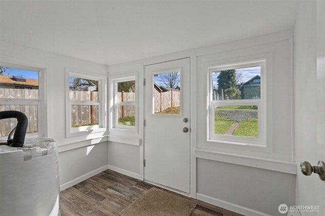 entryway with dark wood finished floors and baseboards