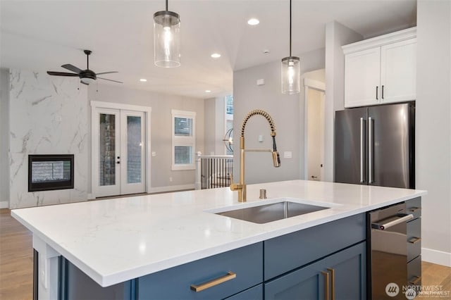 kitchen featuring a ceiling fan, a sink, open floor plan, recessed lighting, and stainless steel appliances