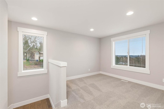 unfurnished room with visible vents, recessed lighting, and baseboards