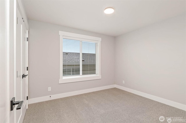 carpeted empty room with baseboards