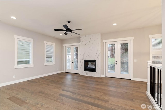 unfurnished living room with recessed lighting, french doors, and wood finished floors