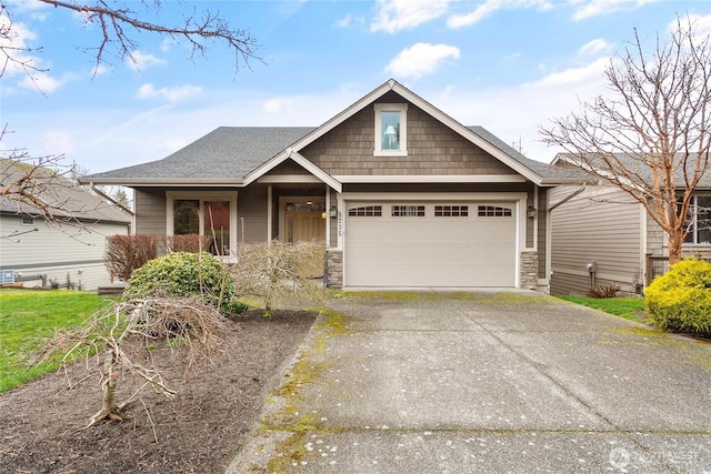 view of front facade featuring stone siding, a garage, driveway, and a shingled roof